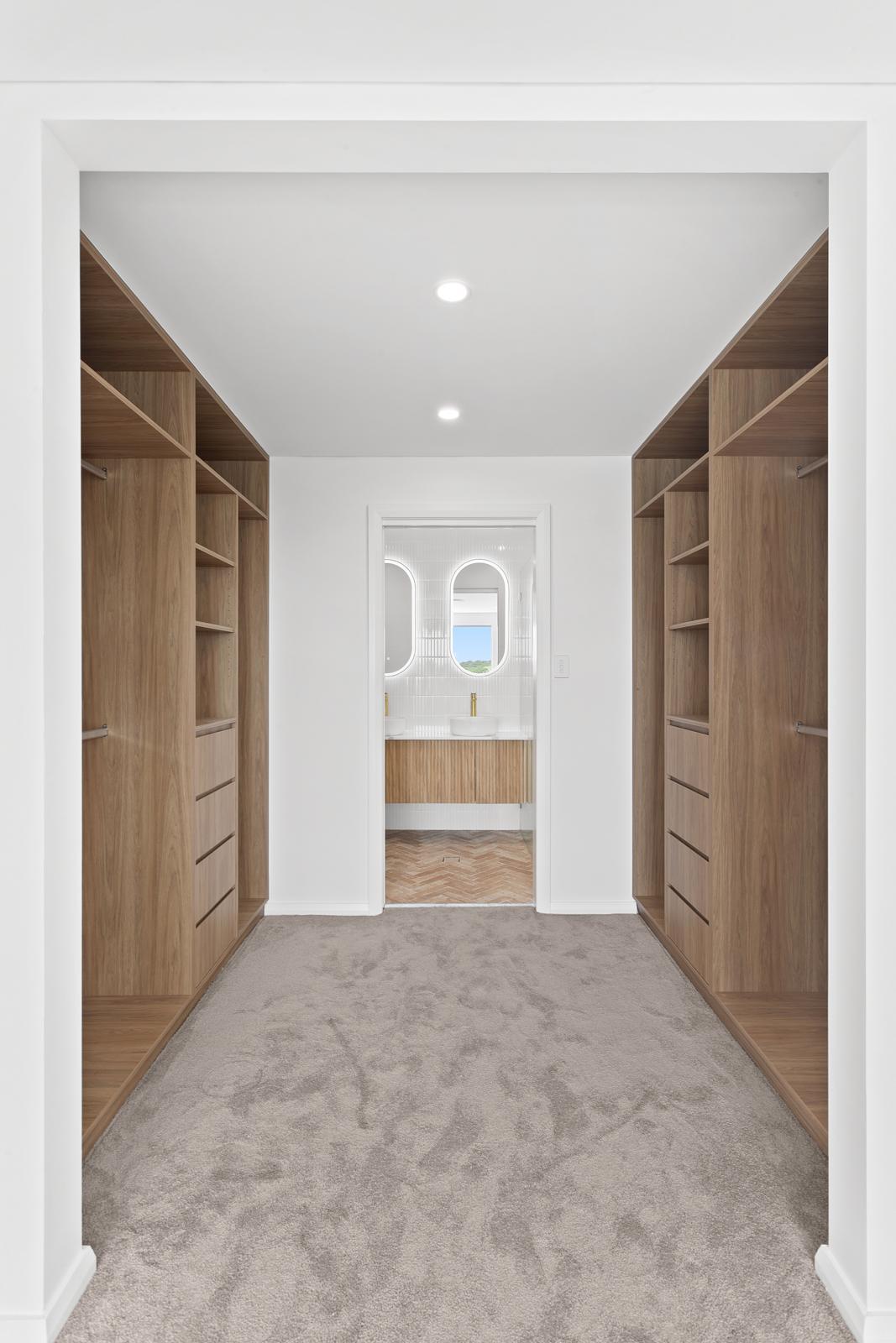 Walk-in wardrobe with oak joinery looking through to ensuite, Malabar