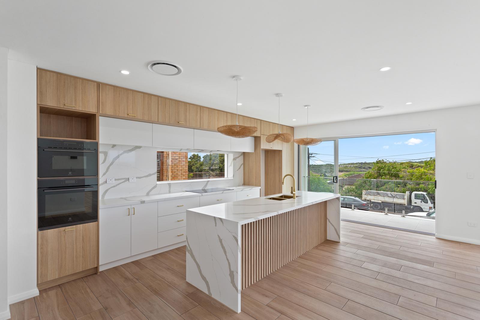 Velocity CG completed kitchen renovation with stone island and harbour views, Malabar project